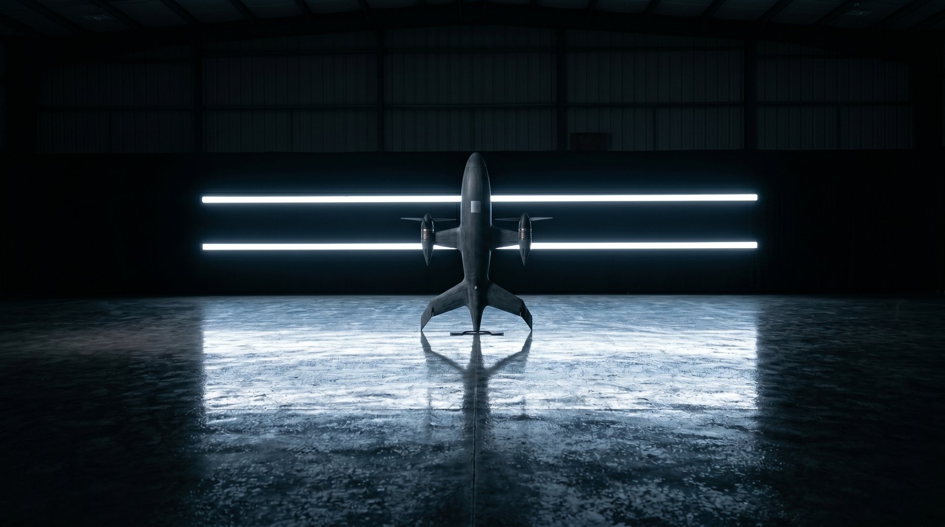 Head-on view of the Varn Gjall autonomous interceptor drone standing on a reflective hangar floor in front of twin horizontal LED light bars.